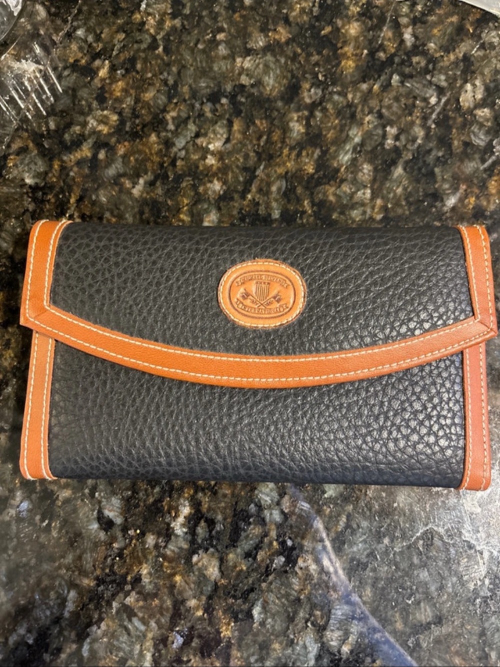 Vintage black and tan pebbled faux-leather wallet from Michael Stevens Internati